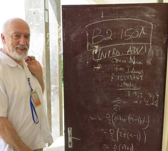 Dan Burns, a mathematics professor at the University of Michigan, stands by a door that doubles as a chalkboard for math students at the University of Buea in Cameroon.